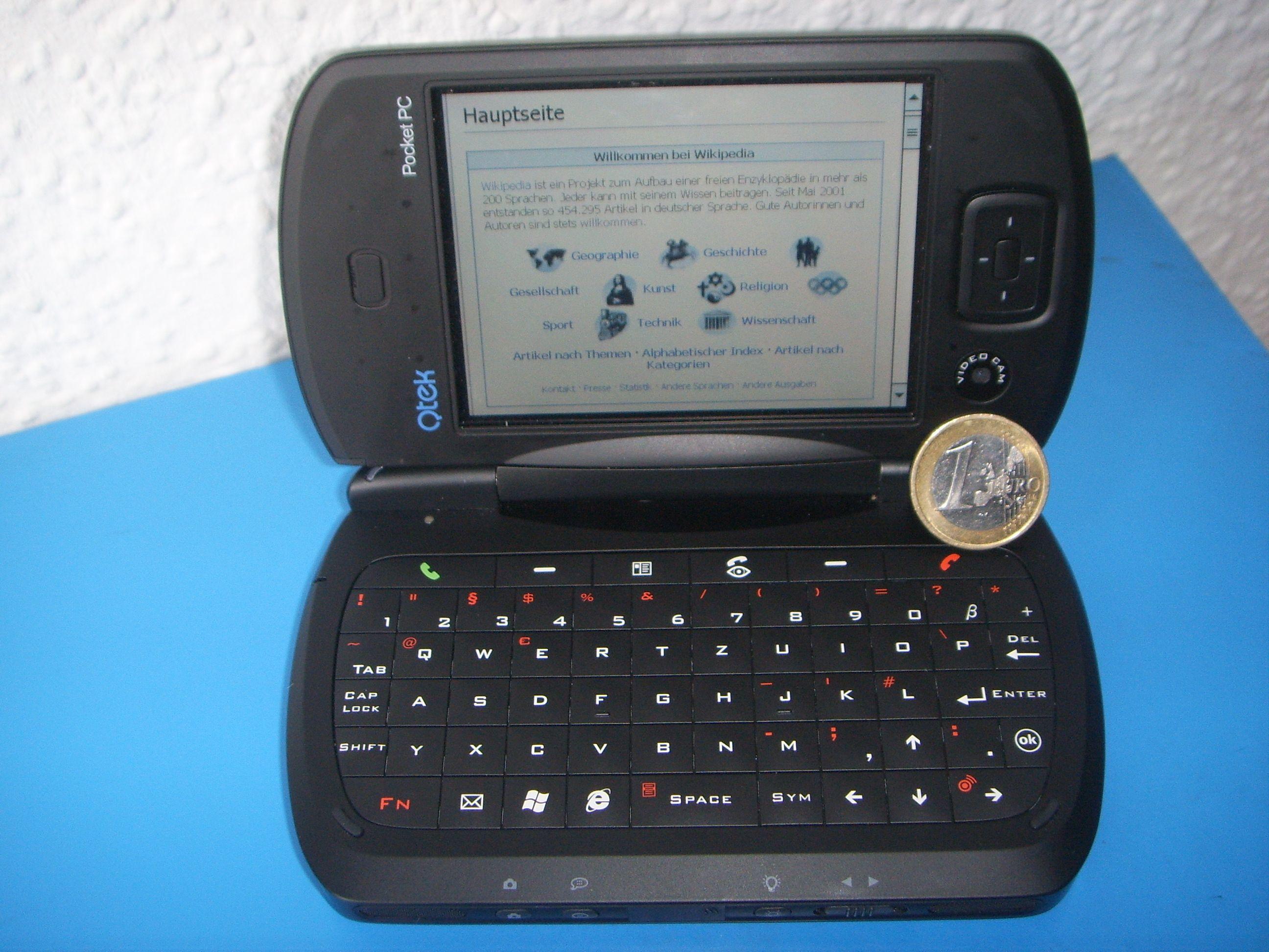 Photo of a "Pocket PC" clamshell device, with a keyboard on one half and a touchscreen on the other.